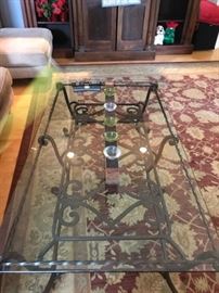 Iron base glass top coffee table.     56" x 30"