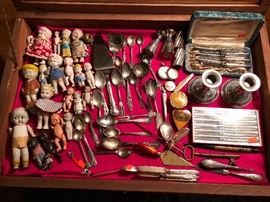 Sterling silver and antique porcelain dolls from Japan and Germany.