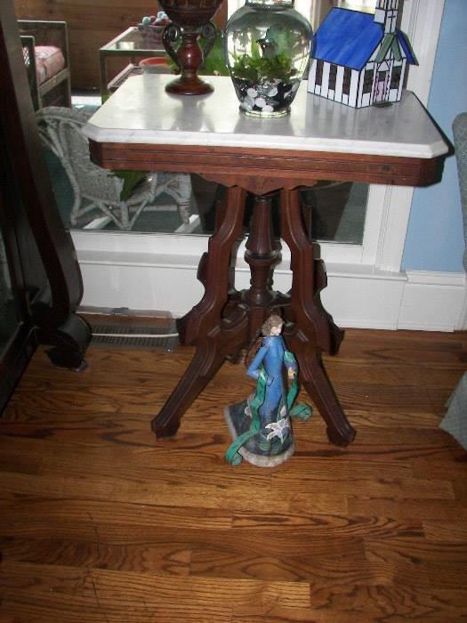 one of several marble top wood tables