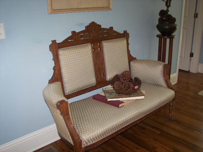 wood carved and upholstered loveseat 