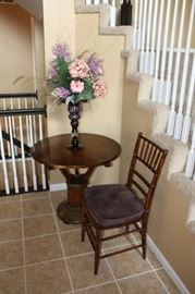 Antique round entrance table or small dining table. This piece is very old and from France. It consist of hammered bronze over wood with parquet top & nail heads on base. Amazing piece. Chair also in great condition but not from the same era.  Note: Flower arrangement no longer available.
