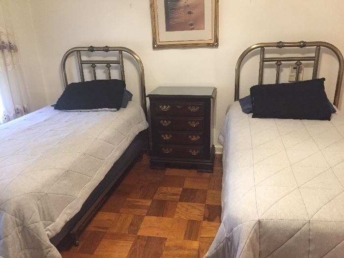 twin beds and one of four small chests