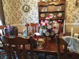 Ethan Allen style dining room table and chairs.   Dinnerware display cabinet in the background.