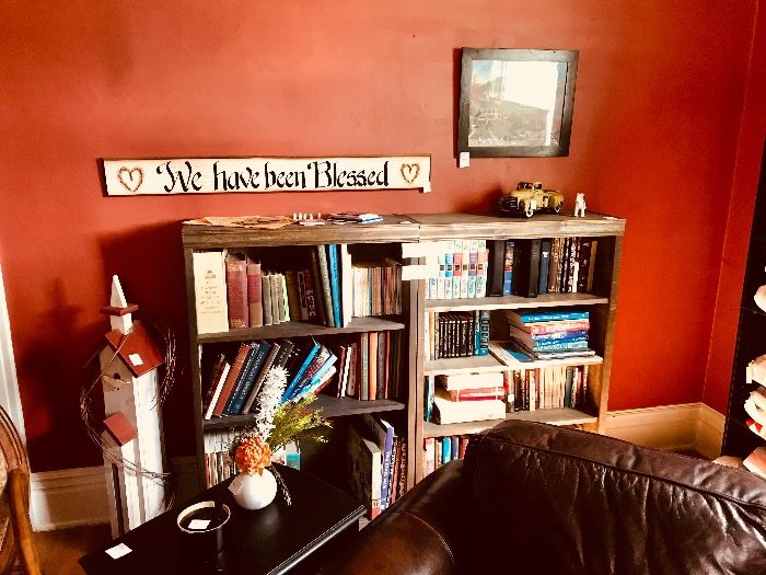 Book collection, end table, bird house, sign