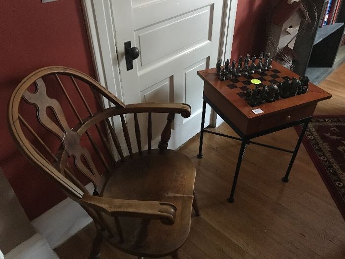 Antique wooden chair and Lord of the Rings chessmen.