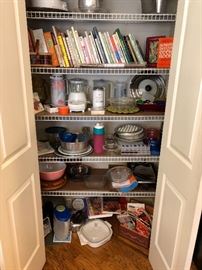 Pantry with lots of use-able things -pink Pyrex bowl, cookbooks