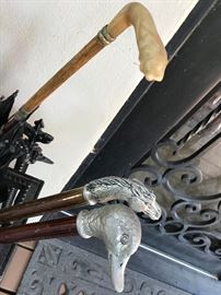 Duck walking stick ($60). Horse head walking stick ($60). Umbrella with carved bone handle ($100)