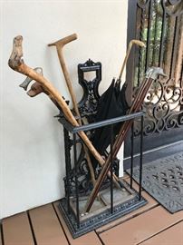 Wrought iron umbrella stand ($150). Vintage walking sticks and umbrella.