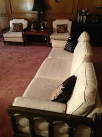 The sofa has a pair of coordinating chairs.