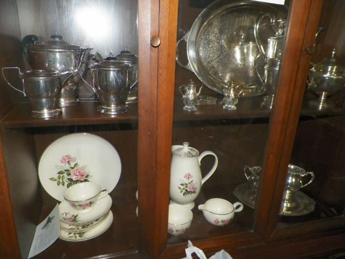 China Closet showing silverplate items along with a 12 piece china set 