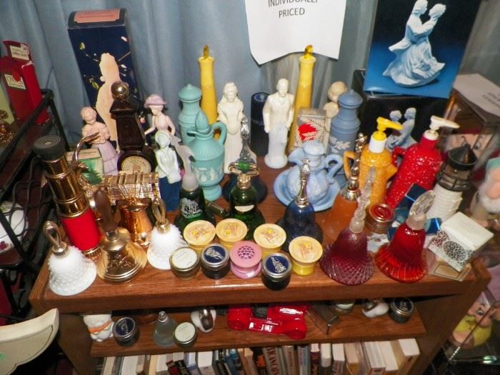 Avon collectible decanters and on the bottom shelf part of the many books on movies and movie stars