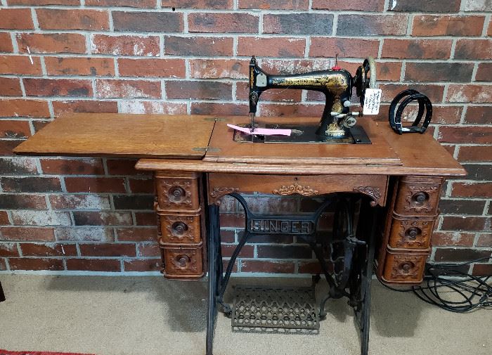 Vintage wood sewing cabinet with Singer machine