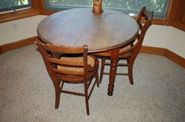 Antique round four leg table with 4 chairs