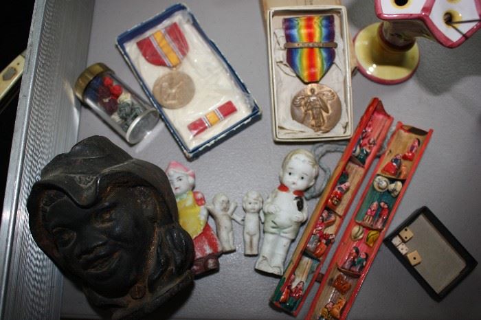 Some old medals (WWI), cast iron band, porcelain dolls, hatpins