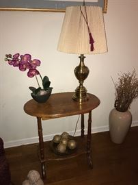 Oval occasional table; artificial orchid; Brass lamp
