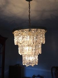 Plexiglass chandelier over dining table