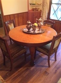 antique clawfoot oak dining table with 6 upholstered chairs. 