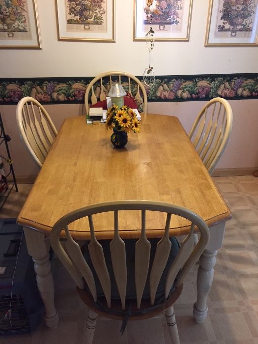 Farmhouse style table with four chairs.