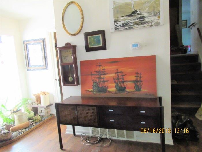 MCM sideboard, has metal handles and front doors along with 4 storage drawers,  along with many nice art selections