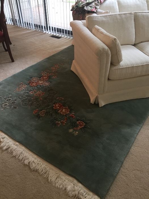 100% wool Chinese floral area rug and ivory love seat