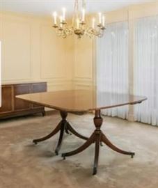 Immaculate Baker Mahogany dining room table, 68"x48" as well as 3 17" leaves.  Comfortably seats 12.  