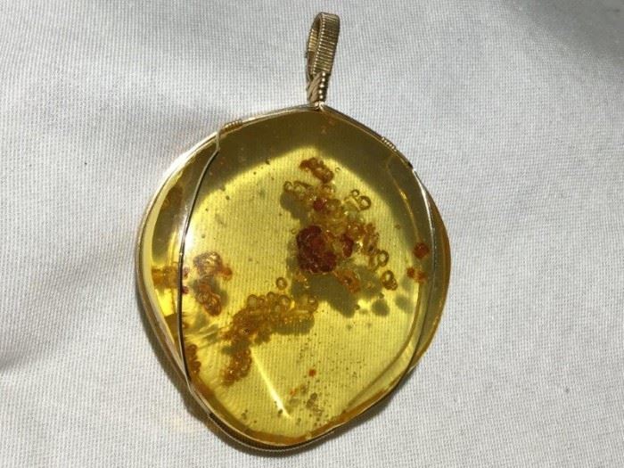  Polished Amber Pendant Set in 10K Gold Wire    http://www.ctonlineauctions.com/detail.asp?id=748146