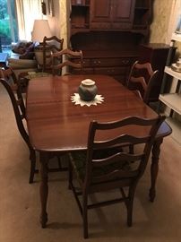 Beautiful table with 1 armchair and 5 side chairs! There is even a matching hutch in background!