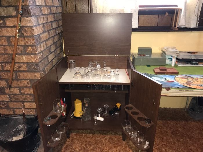 Mid Century bar cabinet open showing supplies inside