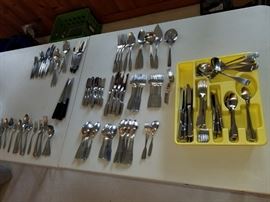 multiple sets of stainless flatware.