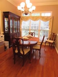 Kincaid Dining Room Set. Lighted china cabinet; table with 6 chairs (2 captain chairs), 2 extension leafs and mat