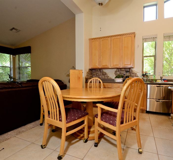 Round Kitchen Table with leaf and 6 chairs. 2 of the chairs have arms.