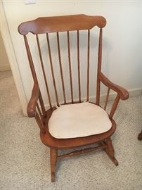 Two solid wood rocking chairs.