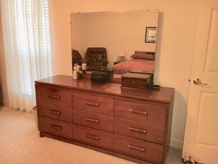 Mid-century modern bedroom group by Ramseur (Ramseur, NC) includes dresser with plate glass mirror, chest, queen bed with bookcase headboard and 2 nightstands. Each piece priced separately, or buy it all at a special price. 