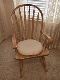 One of two wood rocking chairs.