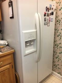 Older Kenmore refrigerator, side by side with ice and water in door.