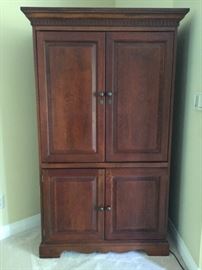 Solid cherry entertainment armoire.