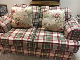 Plaid sofa sleeper and matching loveseat. 