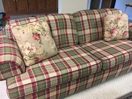 Plaid sofa sleeper and matching loveseat. 