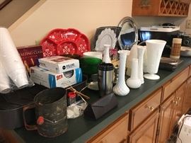 Counter full of glassware, serving items and more.