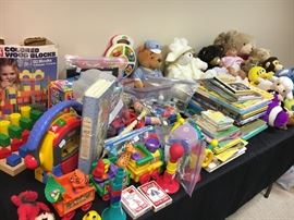 Table full of vintage and contemporary toys and games.