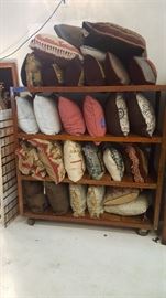 Assortment of pillow. Antique Wooden Rolling Rack