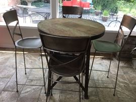 Custom made from Leon & Lulu's 36" round 40" high distressed wood high top table w/metal frame and 2" iron band. Set includes 4 hammered metal stools/chairs also custom made 46" tall with 30" seat height. This is an outstanding, one of a kind set