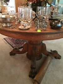 Round antique golden oak dining table, claw feet 