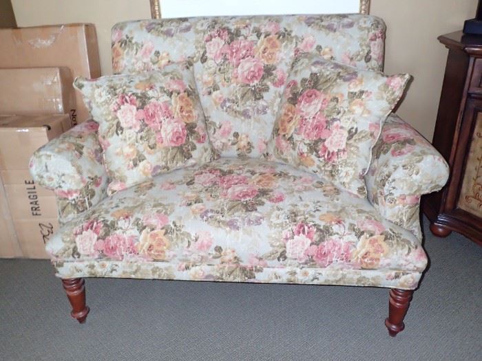 SOFT FLORAL SETTEE WITH TURNED WOOD LEGS