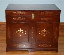 
#2239: Fantastic Inlaid Rosewood Trunk/Coffee Table
Fantastic inlaid rosewood trunk used as a coffee table.

A custom glass piece has been cut for the top. The piece has been perfectly finished with a brass latch.

24"L x 16"W x 20.5"H