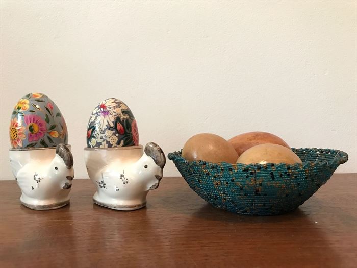 #2204: Two hen porcelain egg holders and egg basket with egg trio
Adorable collection of signed porcelain egg display and trio eggs with bowl.

Bowl, 5.5"D
Hen & Egg, 4"H