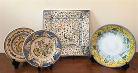 #2207: Set of 4 decorative plates - signed
Lovely collection of European hand painted pottery plates collected from around the world.

Each original piece is signed and ready to be displayed and enjoyed for years to come.

Square 10.25" x 10.25".
Bowl 8.5" Diameter.
2 Small Plates 6.75" Diameter.

Bid per Piece , Final bid x 4