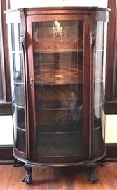 #1421: Demi Lune Antique China Cabinet
Demi lune Antique China Cabinet with curved door and Chippendale lion feet.

39"W x 16"D x 64"H