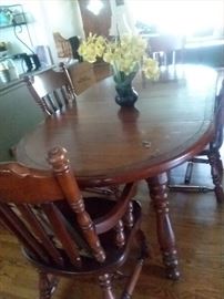 John M  Smythe table with 2 captains chairs and side chairs.  Has two table extensions and felt sided table covers. Part of a set  credenza with lights, glass shelves and side board.  will sell separately.
