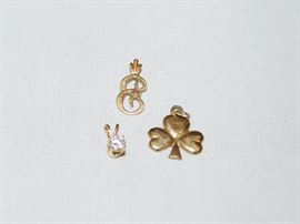 several charms with a 14K diamond pendant 
